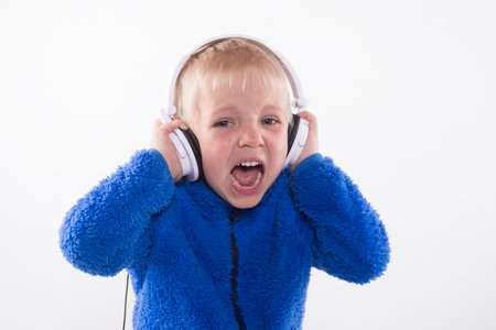 portrait of a young boy with white headphonesの写真素材