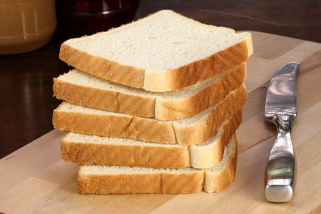 peanut butter and jelly sandwich ingredients on preparation wood board  