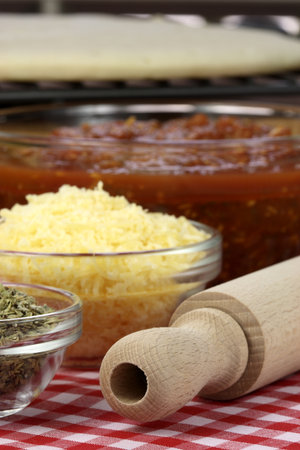 hawaiian pizza ingredients and utensils  on  wood cutting board の写真素材