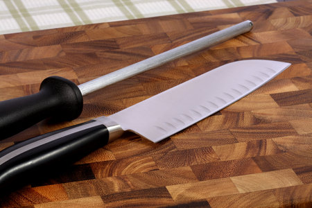 fine kitchen knife and sharpening  on fine wood cutting board