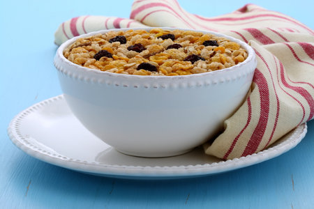 Delicious and nutritious lightly toasted breakfast muesli or granola cereal on vintage styling.