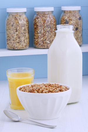 Delicious and nutritious lightly toasted breakfast muesli or granola cereal on vintage styling.の写真素材
