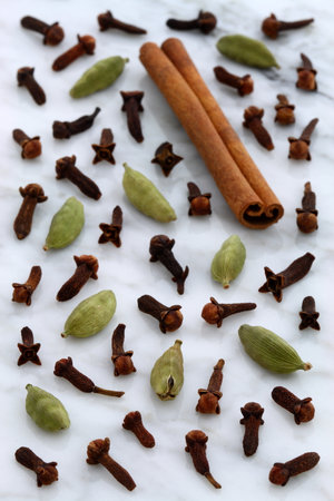 beautiful spices, often used to flavor all kinds of food and drinks, on  carrara marble countertop.の写真素材