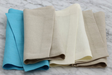 trendy and beautiful linen hemstitch napkins styled on antique carrara marbleの写真素材