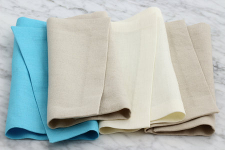 trendy and beautiful linen hemstitch napkins styled on antique carrara marbleの写真素材