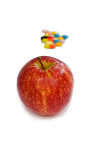 Red apple and pills isolated on white background.の写真素材