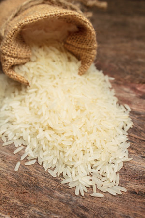 grains white uncooked rice in small burlap sack.の写真素材