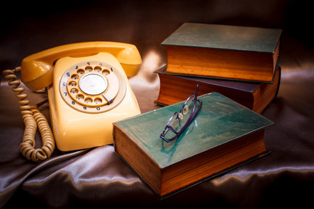 retro phone and book in vintage style.の写真素材