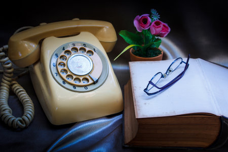 retro phone and book in vintage style.の写真素材