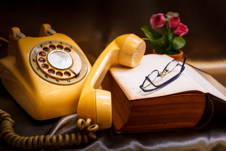 retro phone and book in vintage style.の写真素材