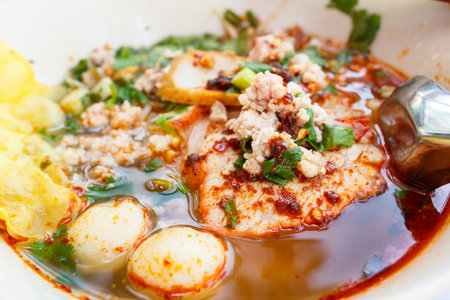 spicy lemongrass flavored flat noodles with pork, thai style.の写真素材