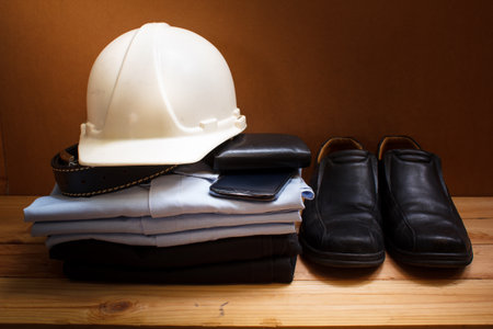 workwear, boots and wallet and mobile on wooden table.の写真素材