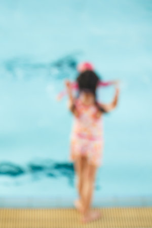 blur of children in the pool, background.の写真素材