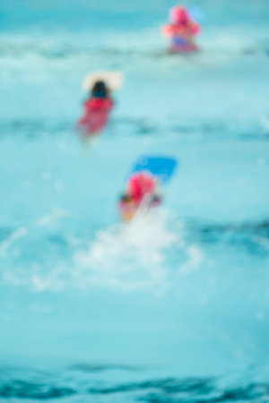 blur of children in the pool, background.の写真素材