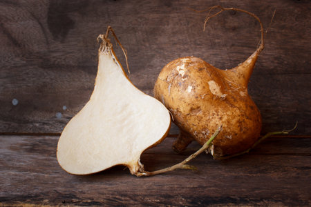 jicama or yam-bean on old wood background, still life.の写真素材