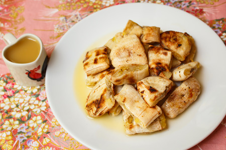 Grilled banana serve with syrup, Thai snack.の写真素材
