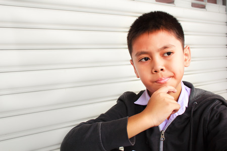 young boy thinking, thailand.の写真素材