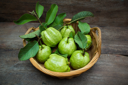 Fresh green guavas on old wood background.の写真素材