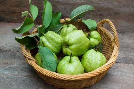 Fresh green guavas on old wood background.の写真素材