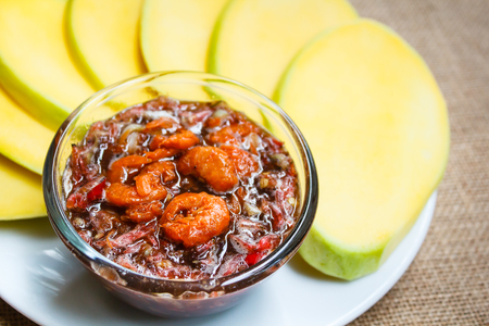 Mango with a sweet sauce made with coconut sugar put prawn, paprika and onion.の写真素材