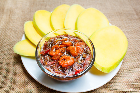 Mango with a sweet sauce made with coconut sugar put prawn, paprika and onion.の写真素材