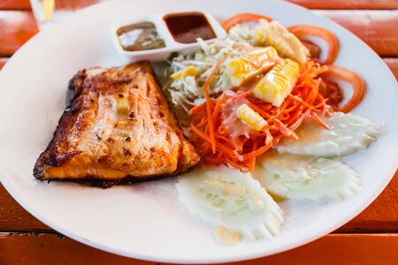 Salmon steak with fresh salad leaf, Thai style.の写真素材