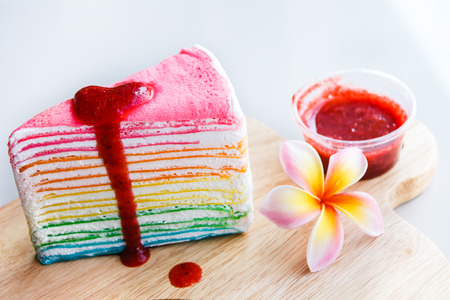 Rainbow crape cake with strawberry sauce.の写真素材