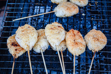 Kao Ji, grilled sticky rice dipped in egg, region food of northeastern Thailand.の写真素材