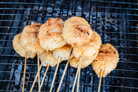 Kao Ji, grilled sticky rice dipped in egg, region food of northeastern Thailand.の写真素材