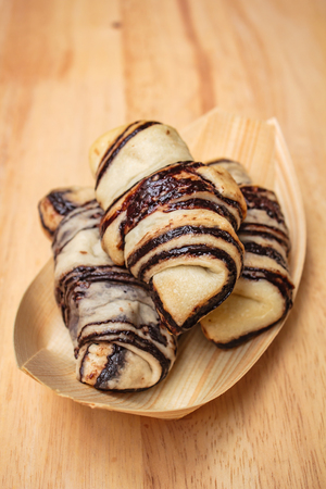 Fresh tasty croissants on wooden background, mini croissants.の写真素材