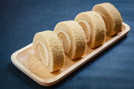 Roll small cake coffee with cream, coffee break time.の写真素材