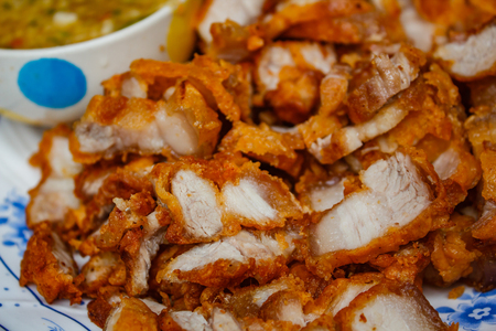 Deep fried crispy pork belly and spicy sauce.の写真素材