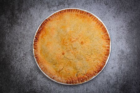 Homemade rustic apple pie on rock black background.の写真素材