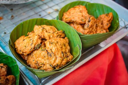 Deep fried fish pasty or fish with red curry pancake and fried basil leaf Served with chili sauce and cucumber slice.の写真素材