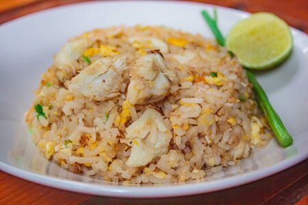 Fried rice with crab and vegetables at restaurant, thai style.の写真素材