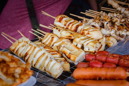 Grilled squid at market street food in Bangkok.の写真素材