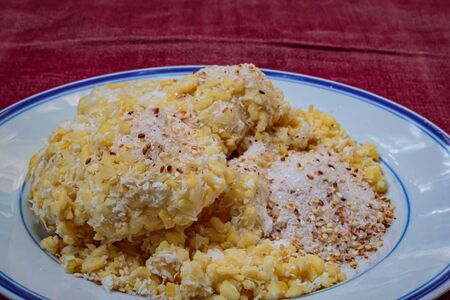 Soft mung bean crepe sprinkled with grated coconut and sugar. Traditional Thai dessert.