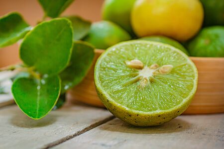 Lemon in basket on white wood, ingredient food concept.