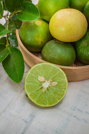 Lemon in basket on white wood, ingredient food concept.の写真素材