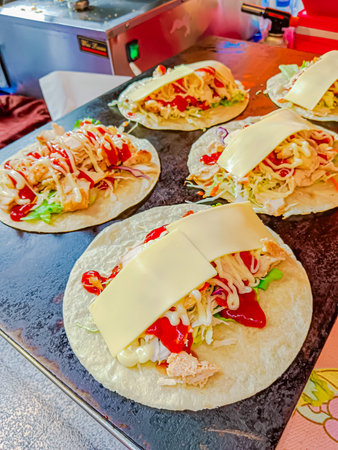 Chicken kebab wrap with lettuce, tomato, red onion and cheese.の写真素材