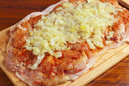 raw chicken piece with spices and onionsの写真素材