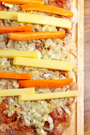 raw chicken piece with spices, onions and carrotsの写真素材