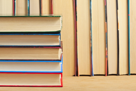 Pile of books on a wooden surface の写真素材
