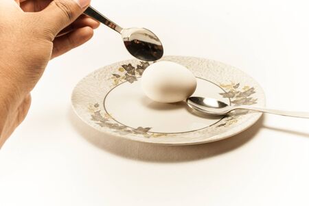 Eating a raw egg with shellの写真素材