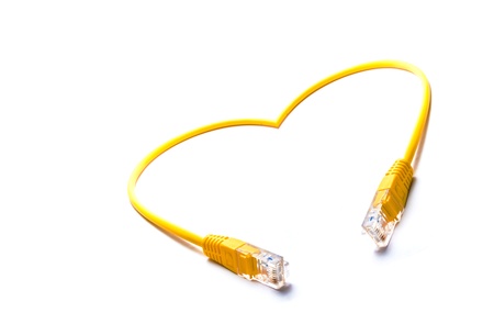 yellow cord with connectors rj45 in love shape on a white backgroundの写真素材