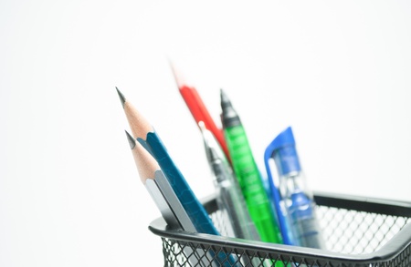 holder with pens and pencils isolated on white backgroundの写真素材