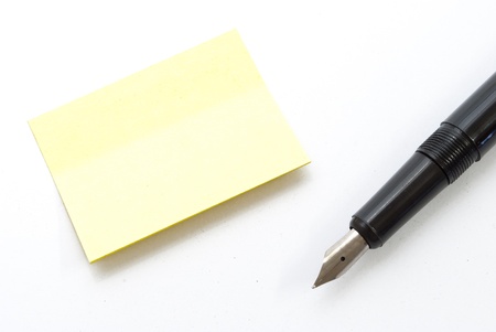 note slip and ink pen on white backgroundの写真素材