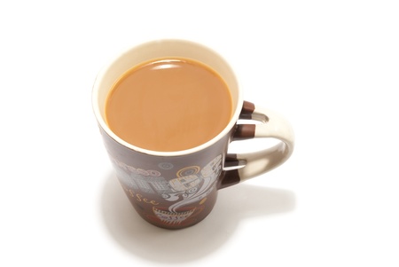 a coffee mug full of coffee with milk on white isolated backgroundの写真素材