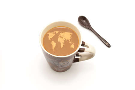 a coffee mug full of coffee with milk and sppon for mixing on white isolated backgroundの写真素材