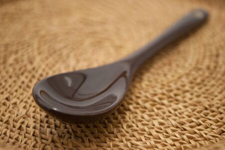 A spoon and a cup of lime tea on isolated white backgroundの写真素材